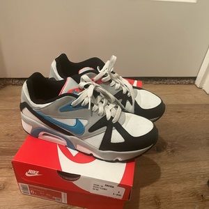 Black/white Nikes with blue/pinkish orange color